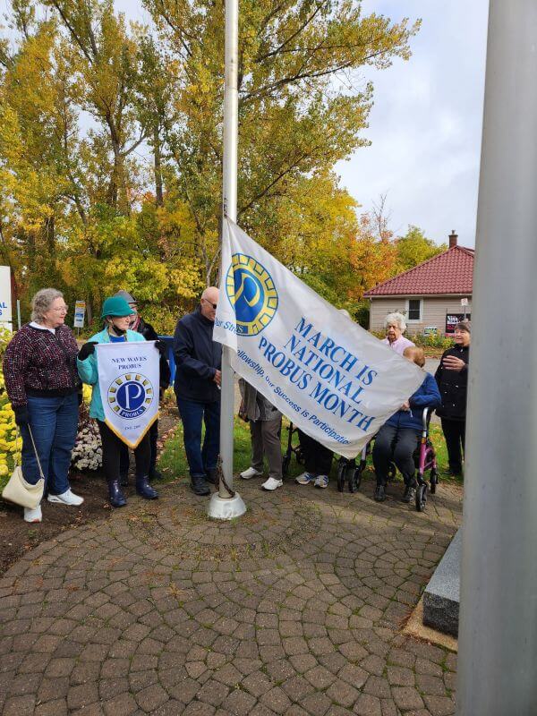 The Flag Being Raised At Town Hall For Probus Month